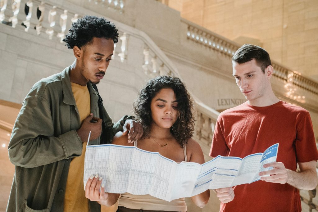 3 people lost looking at map in museum